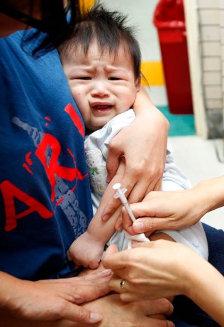 A baby cries as he is given an Influenza A (H1N1) vaccine at a hospital in Taipei